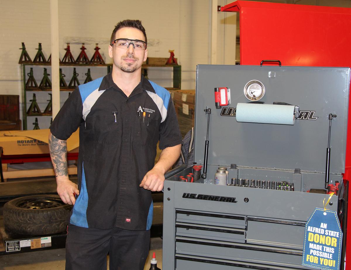 student standing near tool box