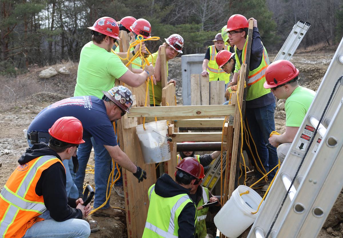 students work on a trench collapse simulation