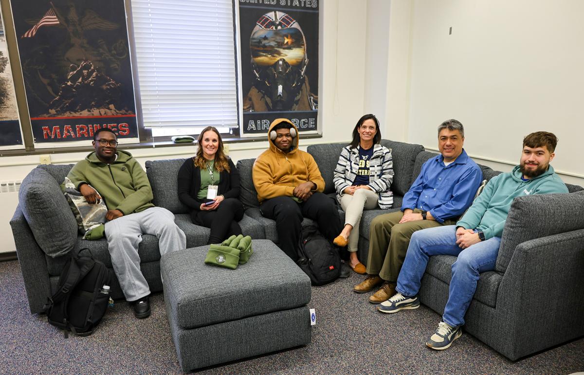 Veteran students sit on new furniture in Veteran's Loung