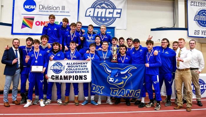 The Alfred State wrestling team poses with the championship trophy and banner after winning the AMCC Championship