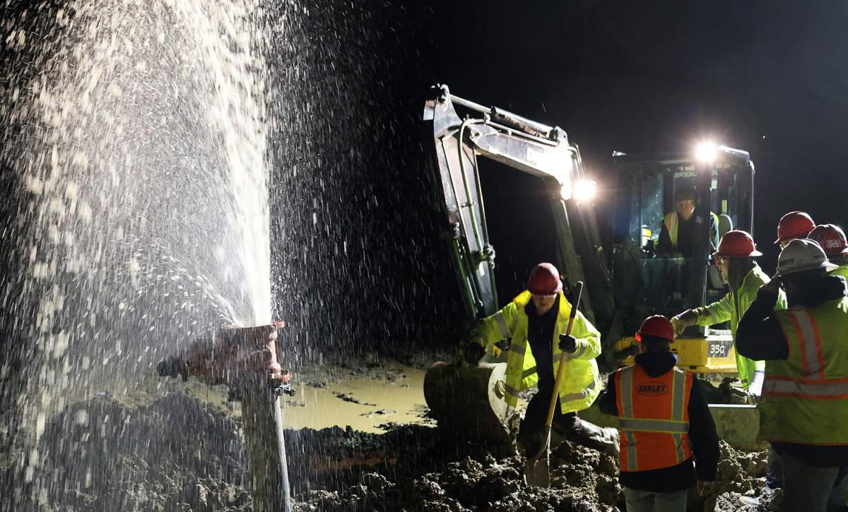 Students work on a water main break