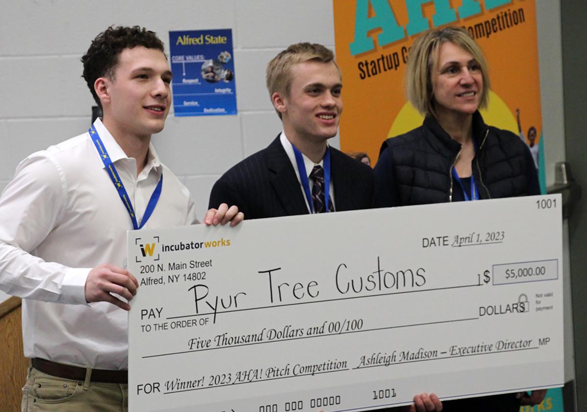students pose with a check