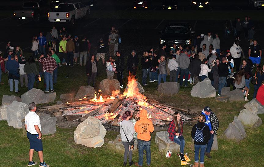 Students gather around a bonfire