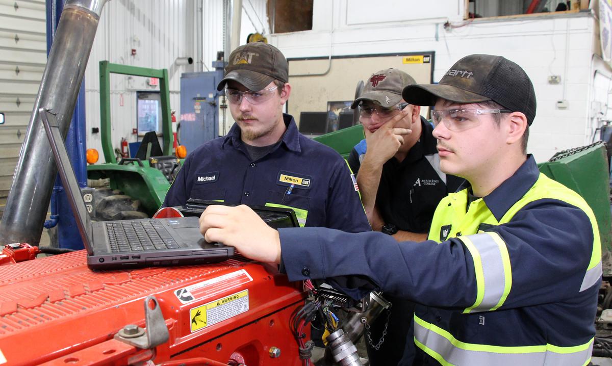 students work on a laptop in the diesel lab