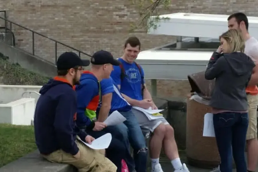Students sitting outside on campus.