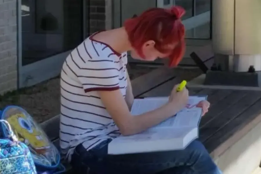 Student sitting outside studying.