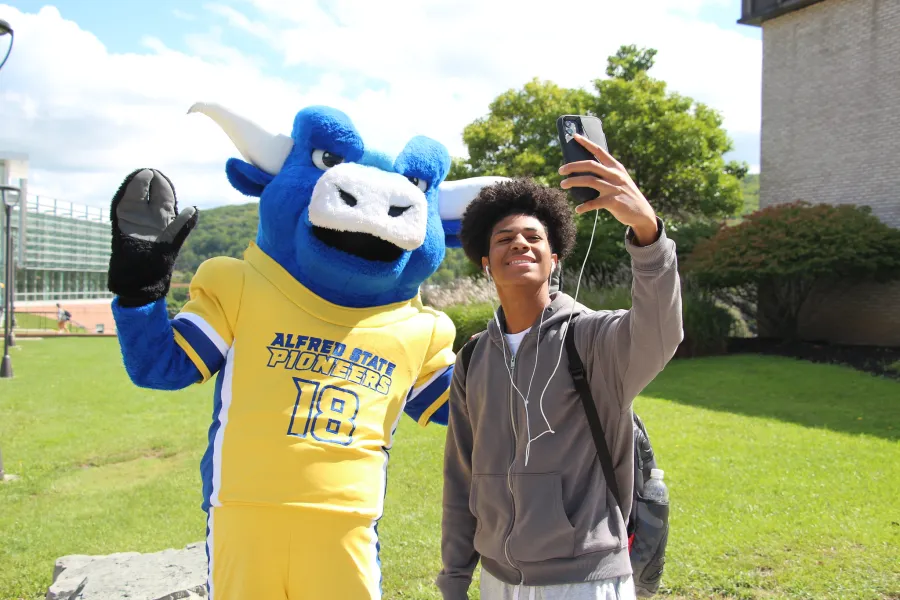Alfred State's mascot, Big Blue, walking on campus