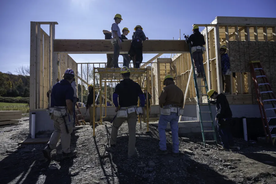 A group of students building a house