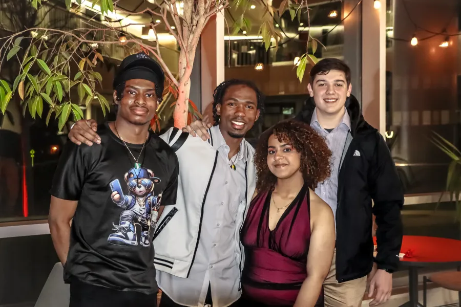 Four students taking a group photo