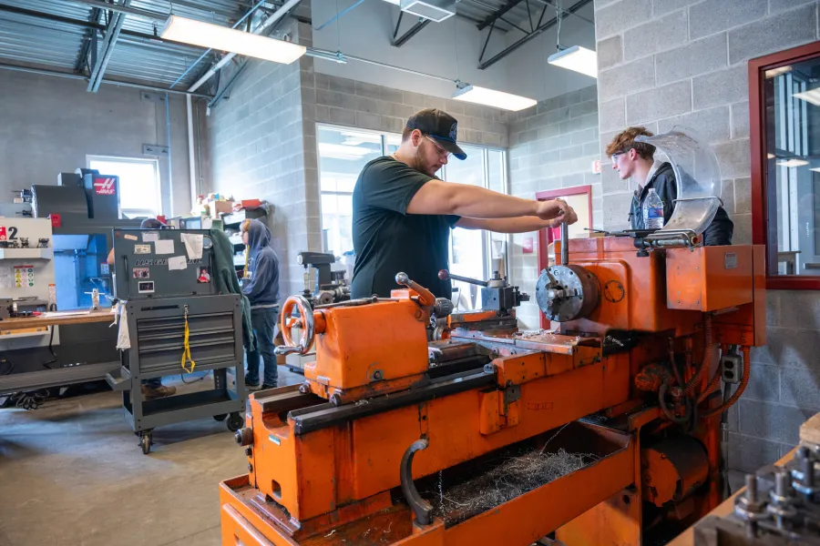 A student working on a lathe