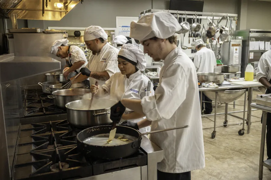 Students working in a kitchen.