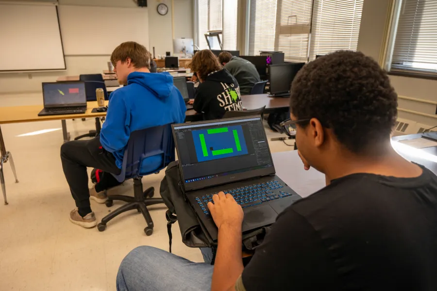 A student developing a game on a computer