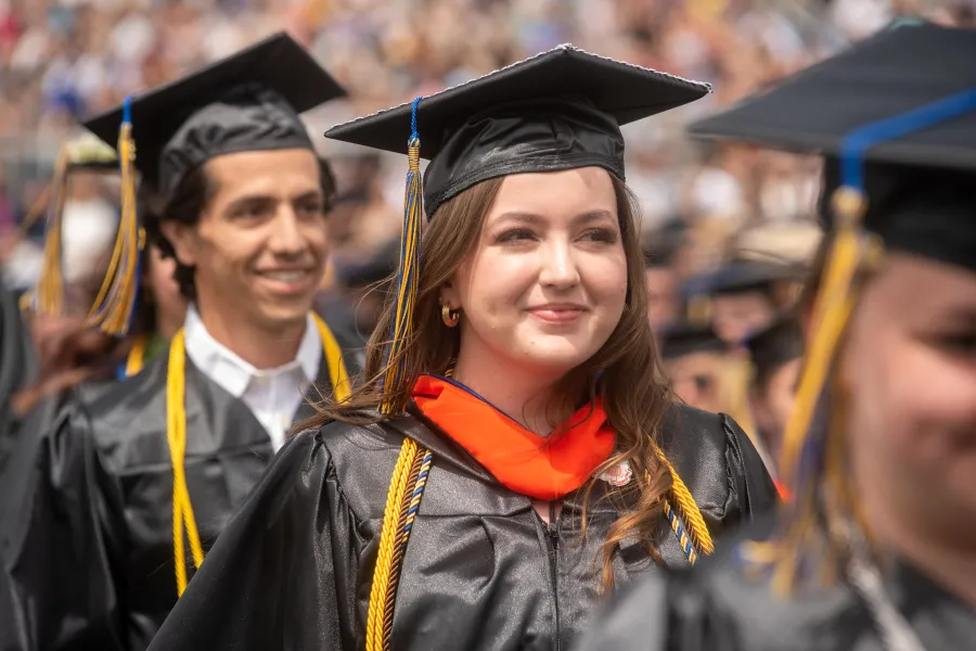 a student wearing their cap and gown at graduation