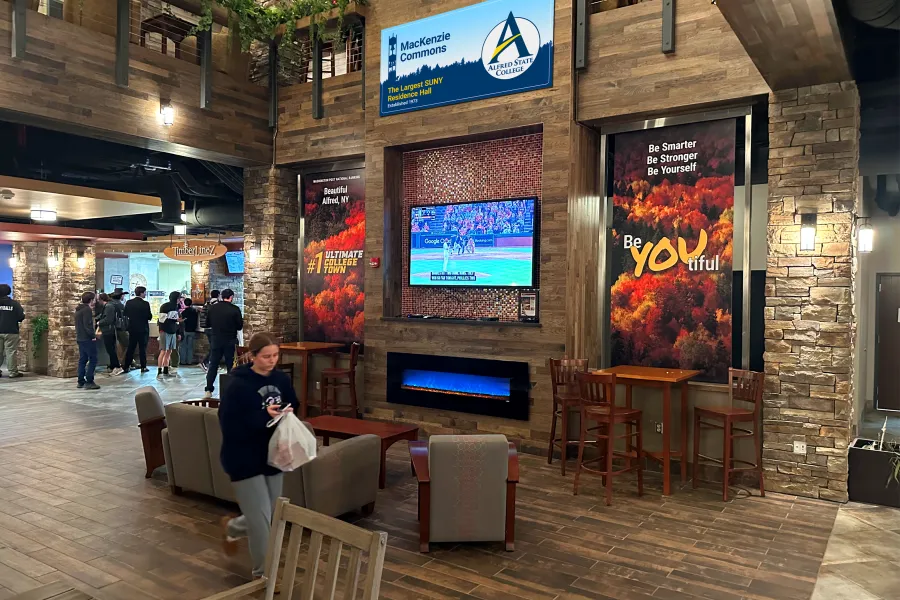 student walking inside MacKenzie Commons