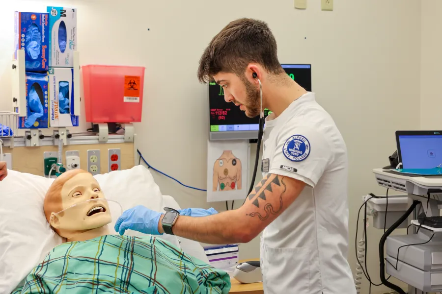 A student nurse practicing care for a manikin 