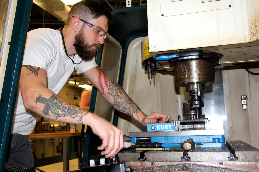 A student working on a CNC router machine