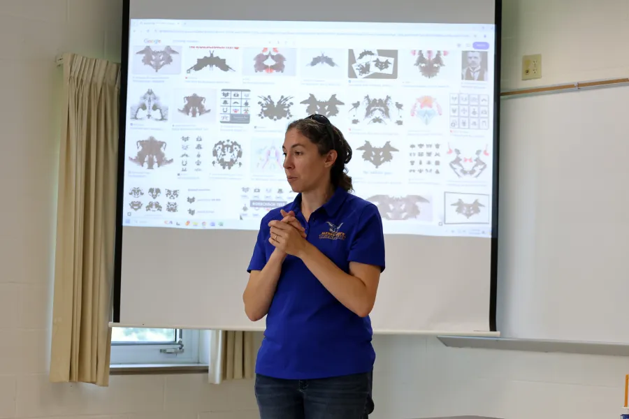A professor presenting in front of a classroom
