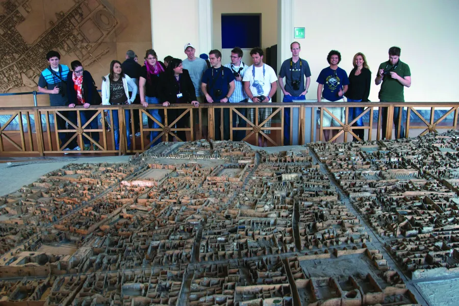 Students in Italy looking at historic architectural models.