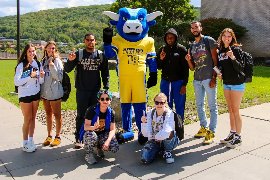Big Blue mascot with a group of students.