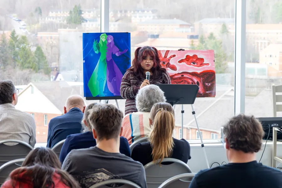 A student reading poetry to a crowd.