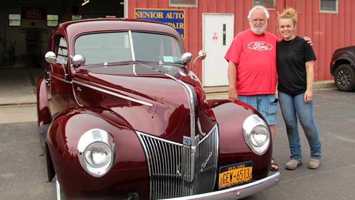 Abigail Clark and her grandfather Jim White stand outside the refinished 1940 Ford Coupe.