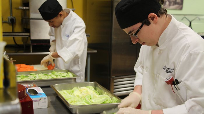 Culinary arts students prepare salads