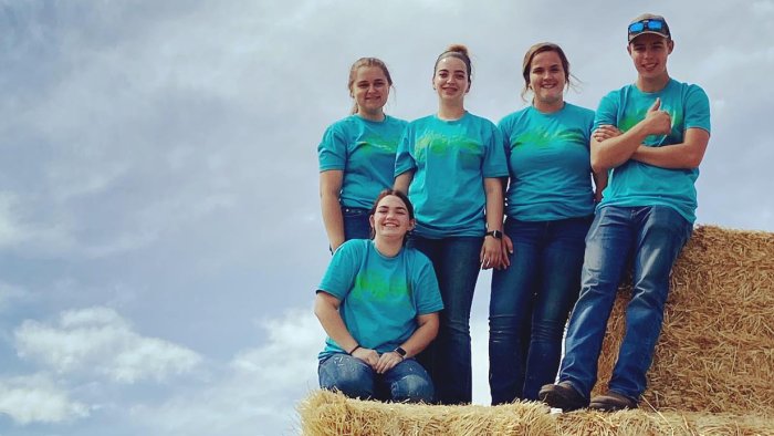 Alfred State agriculture students help at Livingston County Farm Fest (L to R): Hope Avedisian, Elyssa Desotelle (kneeling), Emma Dominic, Abby Beidel, and Tyler Norton.