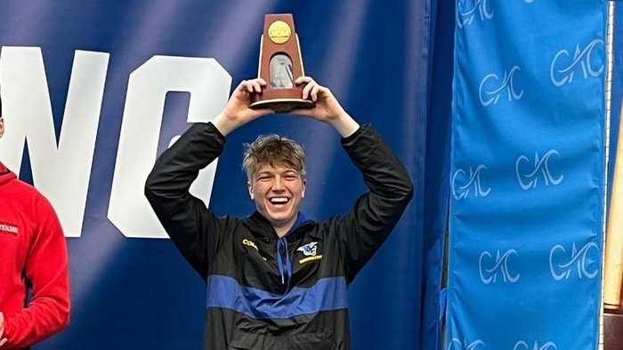 Conor Compton stands on the award stand after capturing 7th place at the NCAA Division III National Championship for performance on the 3m diving board.