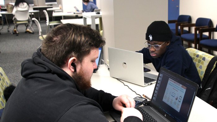 A pair of Alfred State students work together in the Student Success Center.