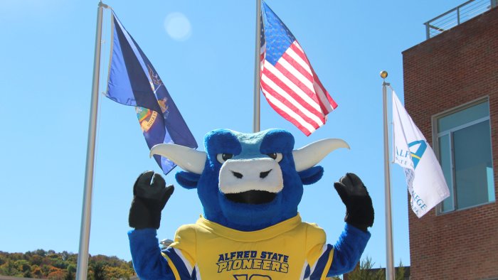 Alfred State’s mascot Big Blue is ready to show the chancellor how the Pioneers are “strong as an ox” when Chancellor King visits Alfred.