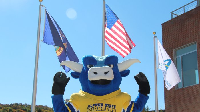 Big Blue in front of the flag poles at the Student Leadership Center