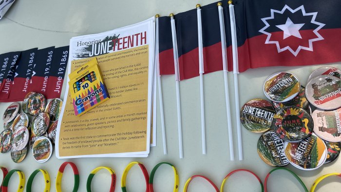 The Cultural Life Center provided information, buttons, and flags about Juneteenth at the Alfred Farmers Market