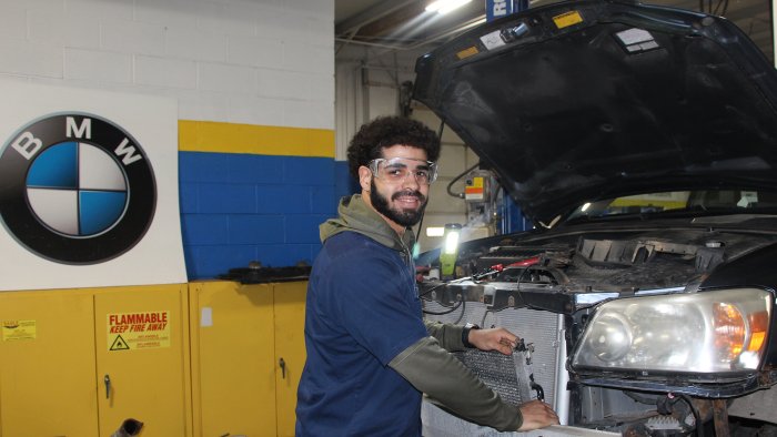 Benjamin Rivera works on a car in the automotive shop