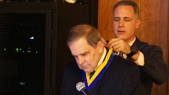 Dr. Mauro put the President's Medallion on Charles Craig