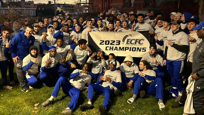 ASC football team with their championship banner