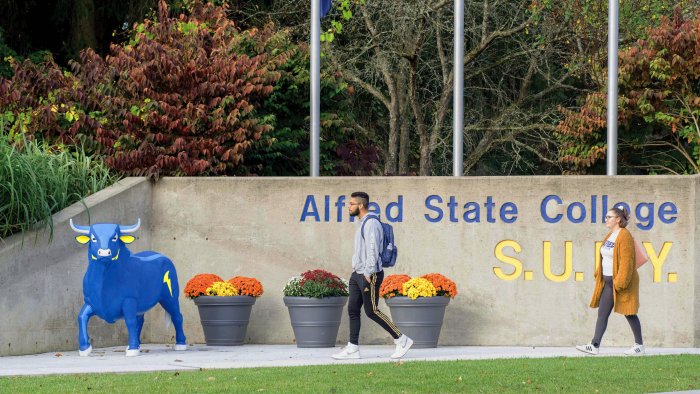 students walk past main entrance of Alfred State