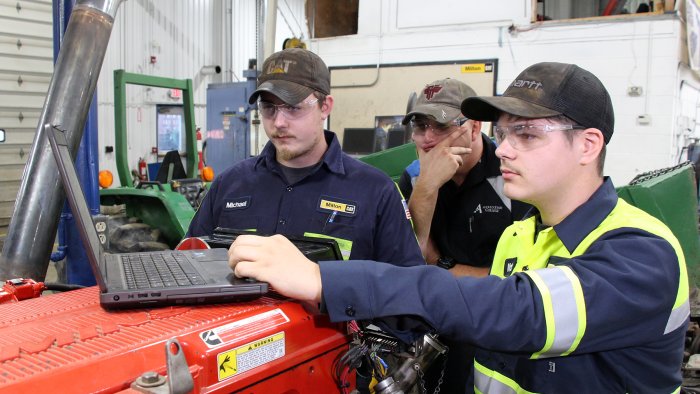 students work on a laptop in the diesel lab