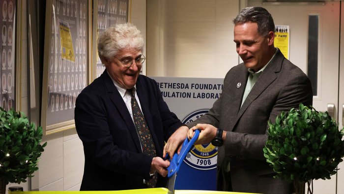 Dr. Mauro and Rob Price cut the ribbon of the new birthing simulator laboratory