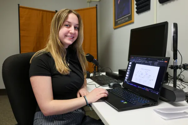 student working on a project on her computer