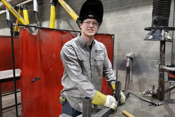 A student in a welding lab at Alfred State.