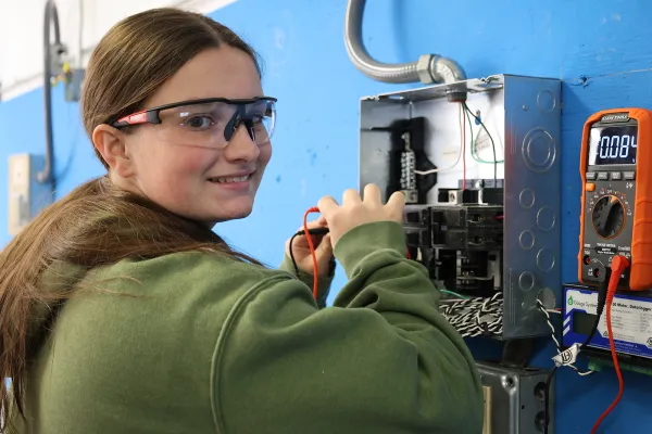 Student working in an electrical box.