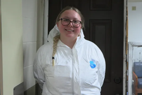 Student in a crime scene recreation at Alfred State.