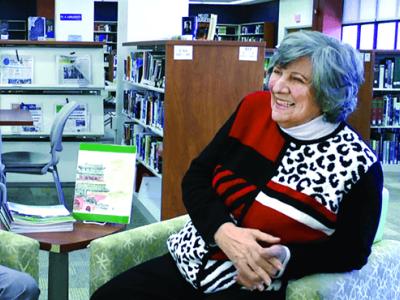 Dr. Constantine seated in the library
