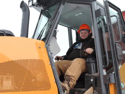 Austin driving a piece of heavy equipment