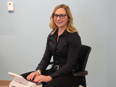 Carissa Kelsch sitting at a stenography machine