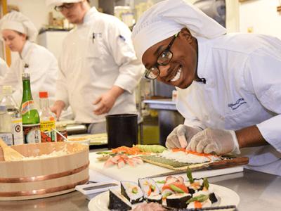 Charles Richards in a kitchen preparing a sushi dish