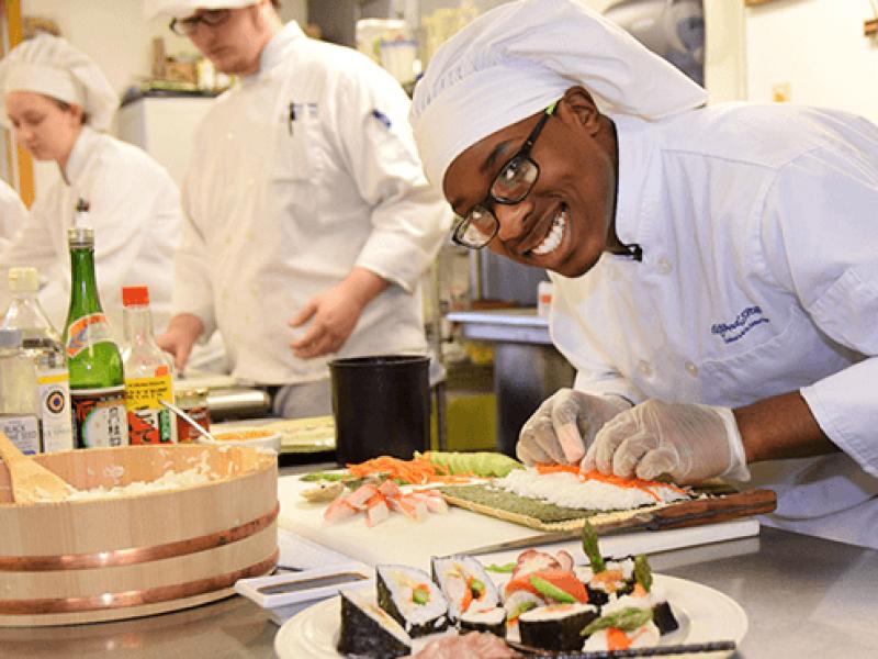 Charles Richards in a kitchen preparing a sushi dish