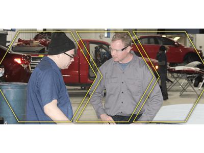 Christopher Tremper with a student in the automotive lab