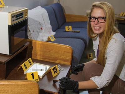 Christy Dodd kneeling next to a chair