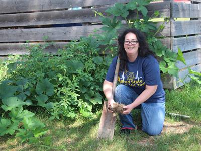Jessica Hutchison works on the soils in the college garden